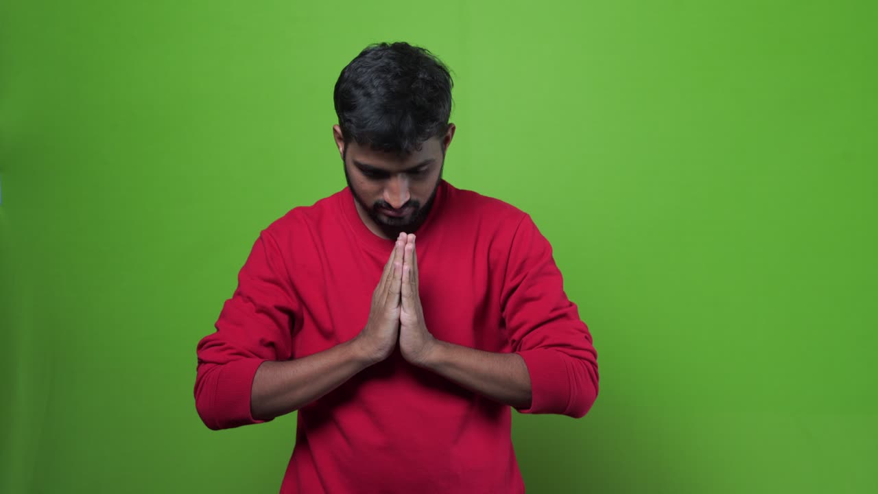 Portrait of happy Indian guy on green screen