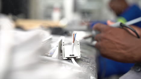 electrician pre soldering led-bar in preparation for soldering together with power cables. slow motion.