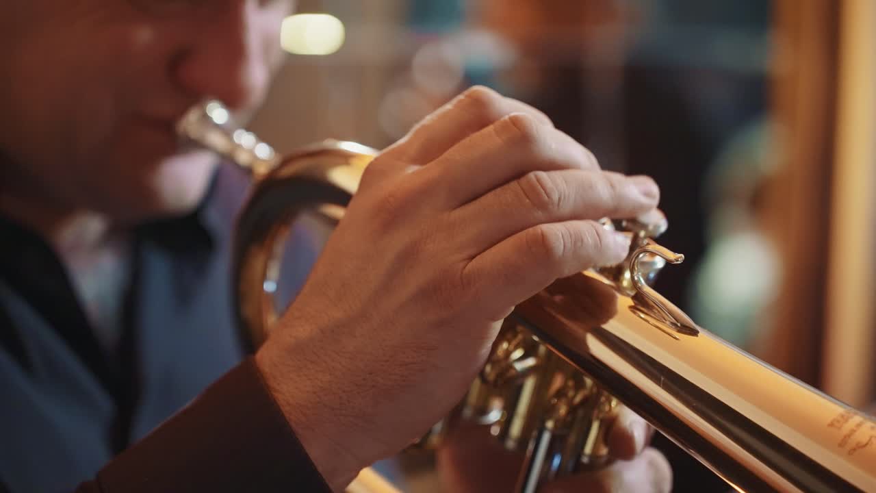 Close-up of Musician's Hands Playing a Golden Trumpet