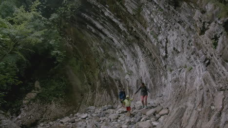 family hiking through a rocky gorge