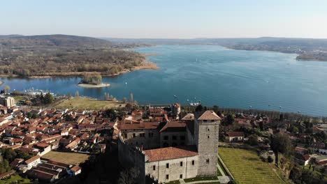 Eine-Mavic-Luftdrohne-Bewegt-Sich-Vorwärts-Rocca-Di-Angera-Und-Enthüllt-An-Einem-Sonnigen-Tag-Die-Wunderschöne-Seenlandschaft