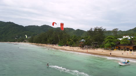 aerial following kite surfers off sairee beach, the longest beach on the koh pha-ngan island