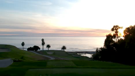 aerial view of the golf course with the oceanside view during sunset