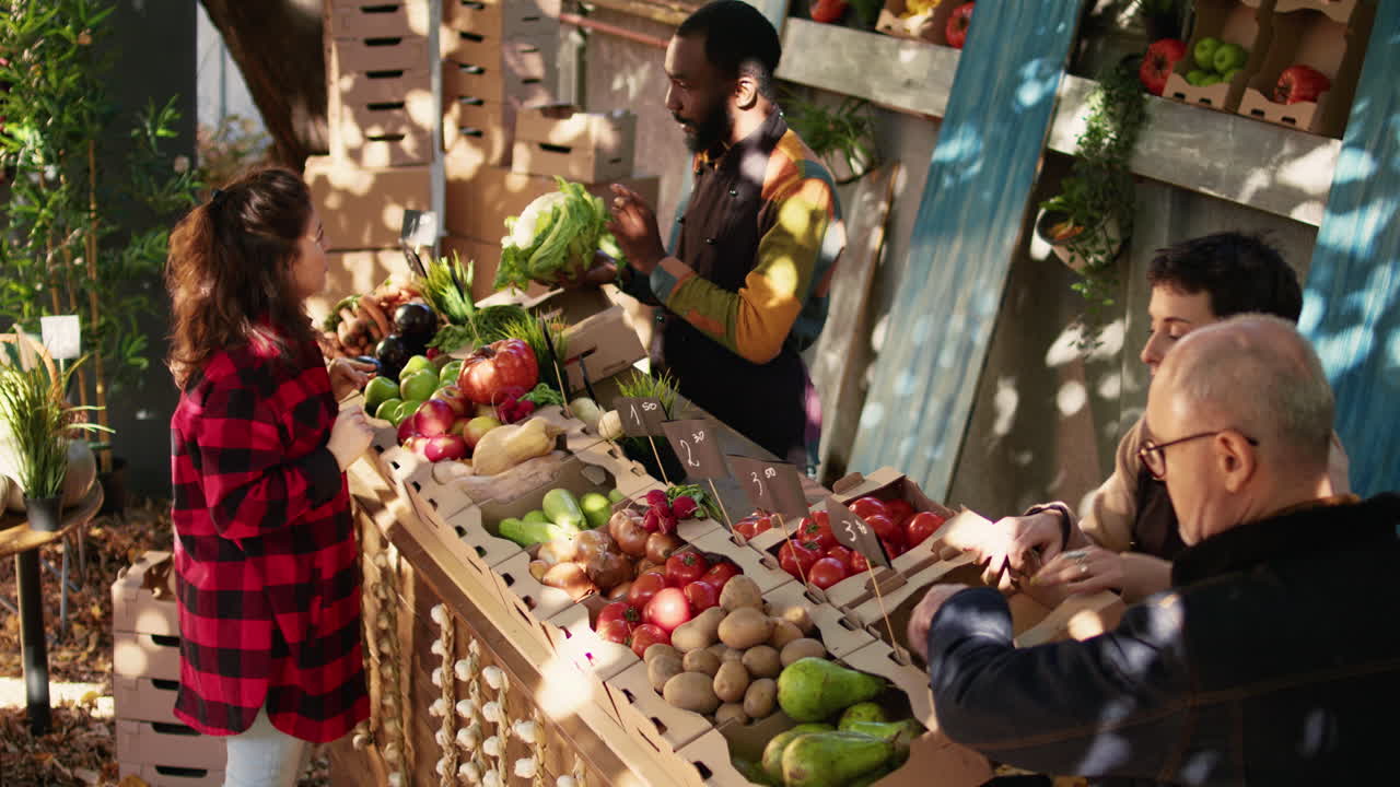 People buying fresh vegetables at a farmers market