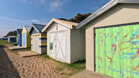 vibrant beach boxes along sandy path