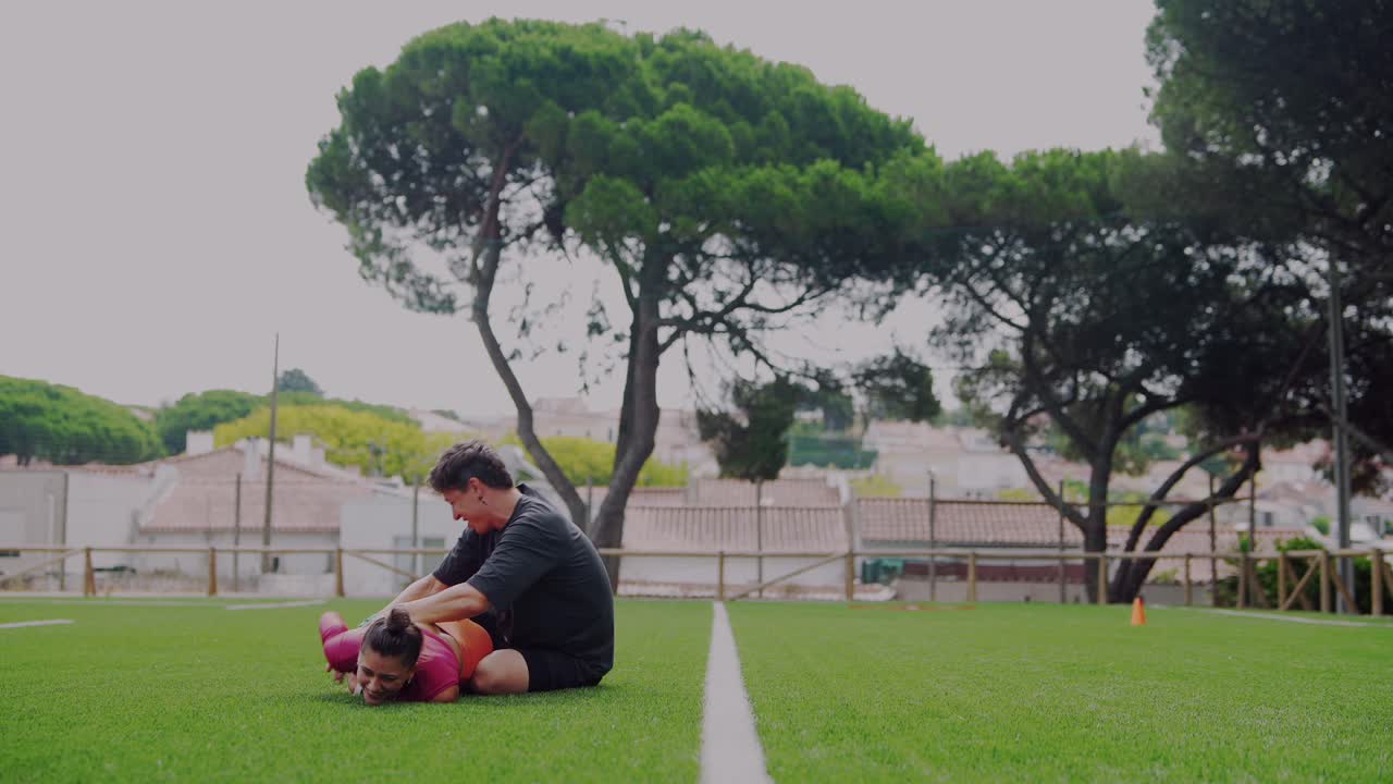 People playing rugby on a green field