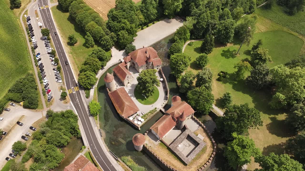 aerial view of schloss hallwyl with moat and lush forest in switzerland