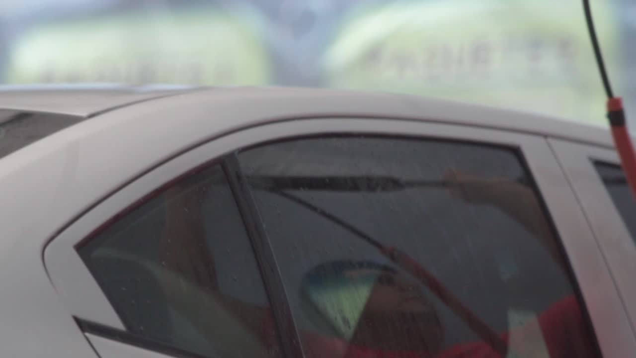 Car Wash - Cleaning Car Exterior With Pressure Washer Spray At Garage. slow motion