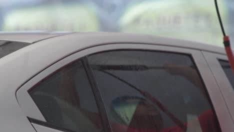 car wash - cleaning car exterior with pressure washer spray at garage. slow motion
