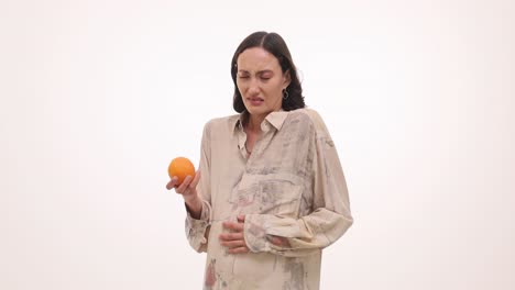 pregnant woman experiencing nausea or morning sickness from an orange