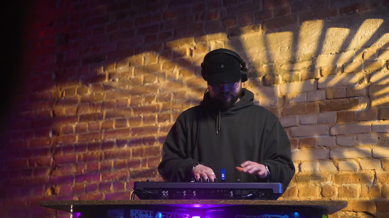 Man with black cap djing at the disco