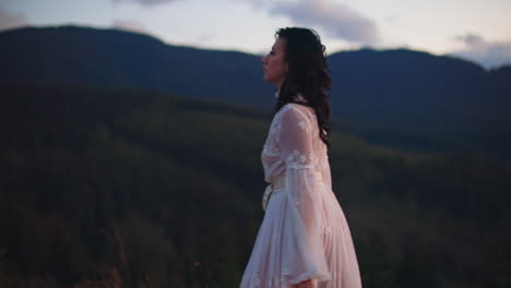 Woman in White Dress at Sunset in Mountains