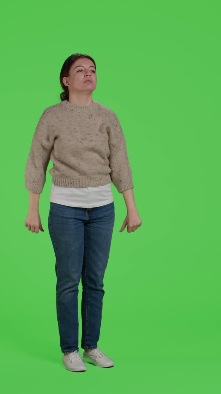 Vertical video: Side view of young adult expressing thumbs down sign on camera