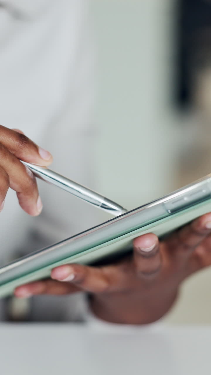 Close-up of Hands Using Digital Tablet with Stylus