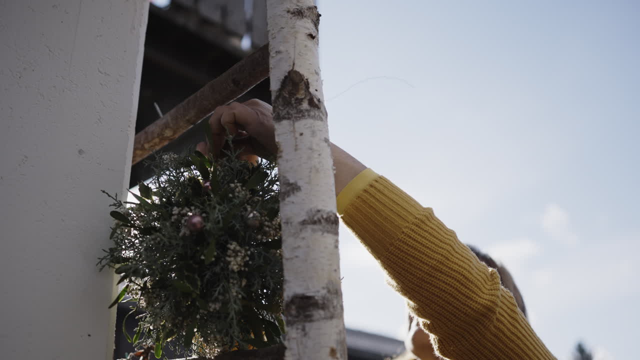 Hanging a Wreath on a Ladder