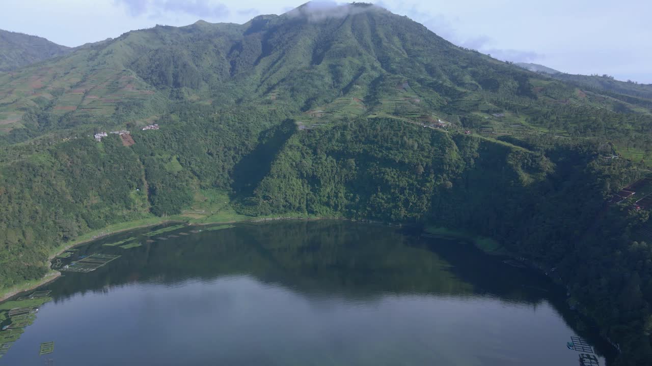 Fly over lake with mountain on the background