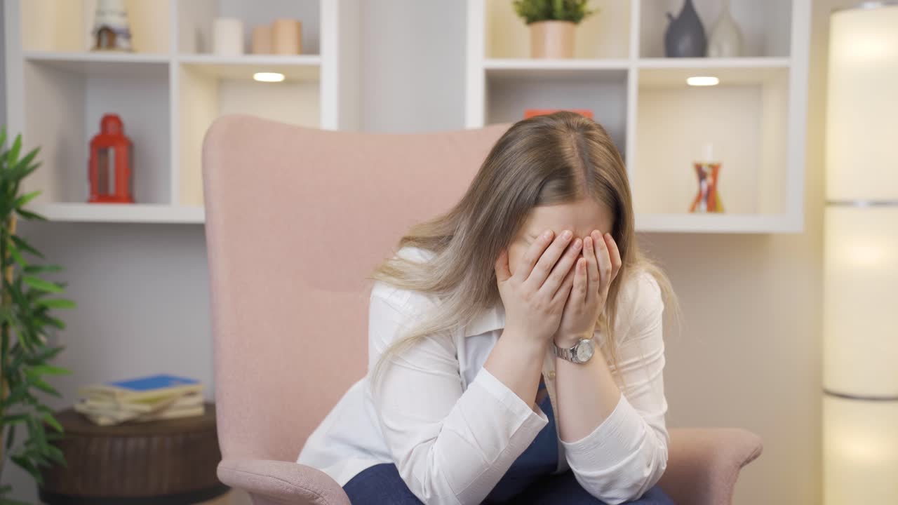 Sad young woman is crying.