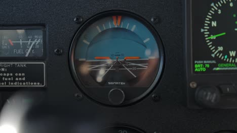 standby attitude indicator on flying airplane instrument panel - cu