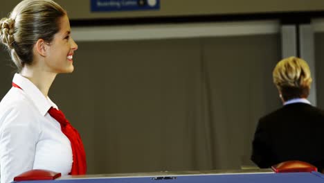 passengers showing their boarding pass at the check-in counter