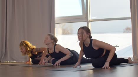 women practicing yoga in a studio