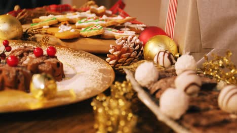 Close-up-of-various-christmas-desserts-and-gifts