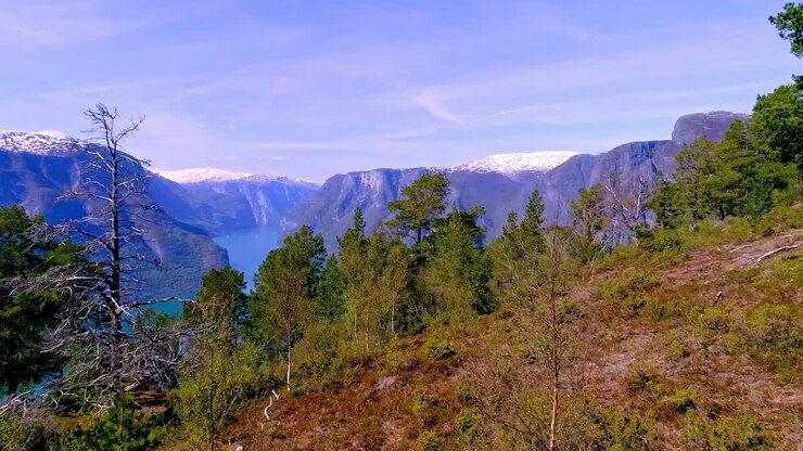 Stunning aerial of beautiful light in the stunning mountains and a blue lake in the valley in the soft daylight