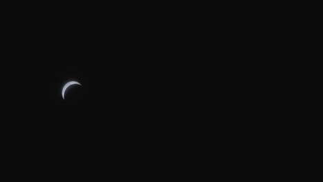 moon partially obscuring sun during solar eclipse.