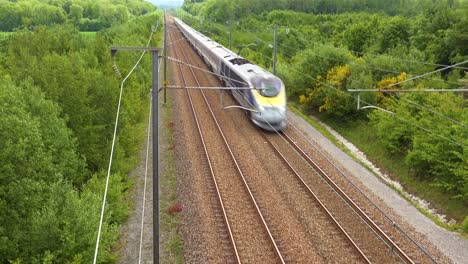 a high speed electric passenger train passes through the countryside of normandy france 3