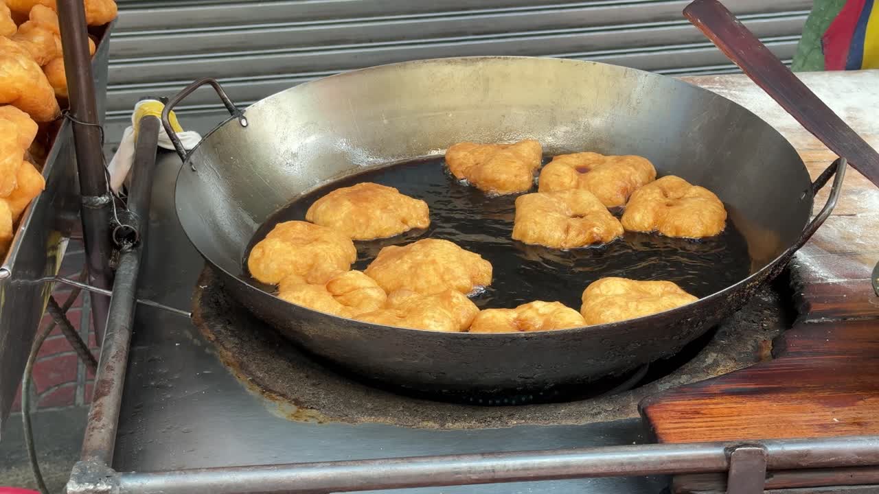 Famous Thai street food 'Patonggo' deep fried on a wok pan