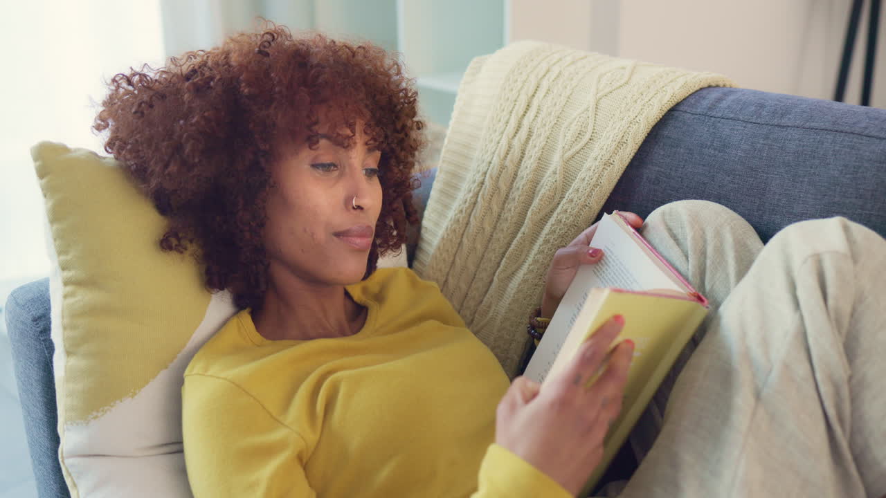 Beautiful afro woman reading intriguing book