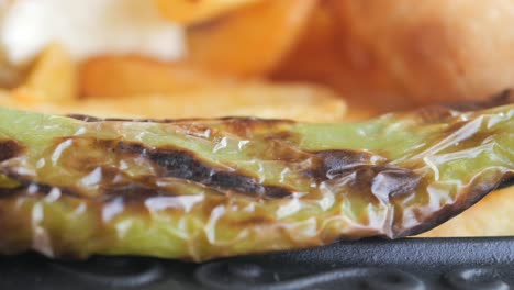 close up of a grilled green pepper