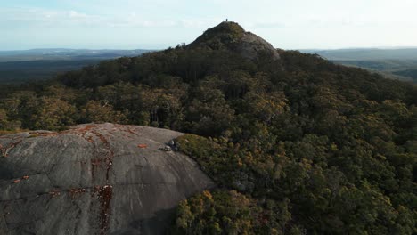 ascending drone shot revealing Mount Frankland summit and the landscape in the background on a cloudy day, Walpole region, Western Australia