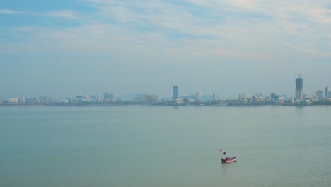 financial indian capital mumbai skyline, fishermen boats and the bandra–worli sea link bridge, called rajiv gandhi sea link. mumbai (bombay) maharashtra, india