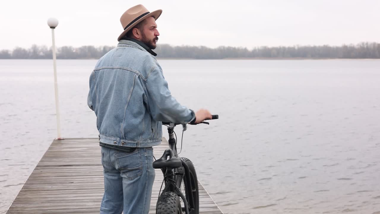 Man with Fat Tire Bike on a Dock by the River