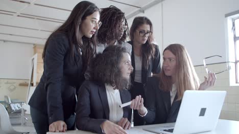 focused businesswomen using laptop in office