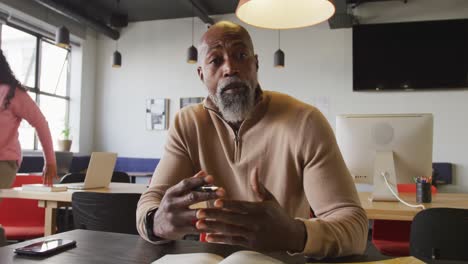 Portrait-of-african-american-businessman-looking-at-camera-at-office