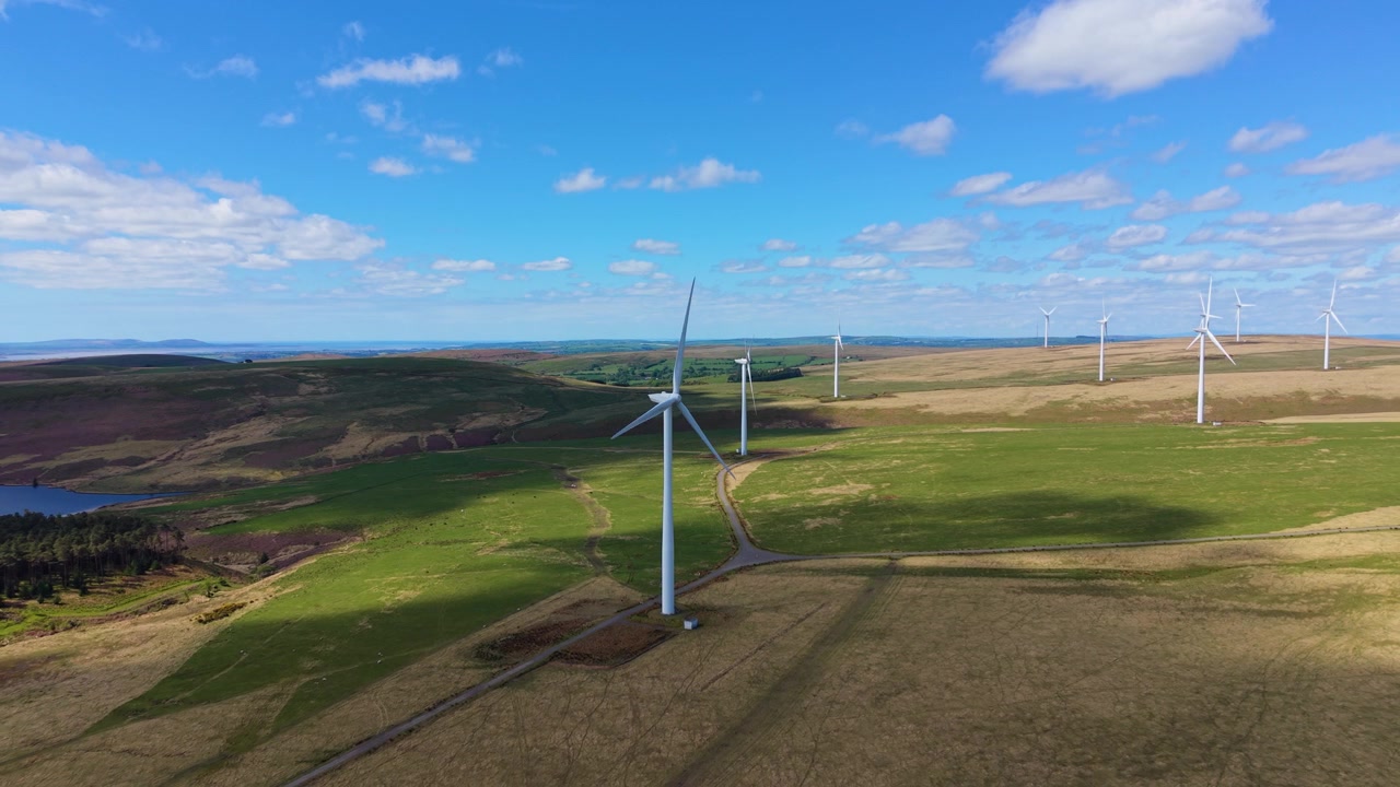 Wind Farm Over Beautiful Natural Countryside in Wales. Aerial Drone Clip of Renewable Energy Generation Infrastructure in UK. 4K.