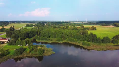 panorama of alsunga city lake with large wind turbines for electric power production in latvia-5