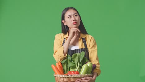 woman holding basket of vegetables