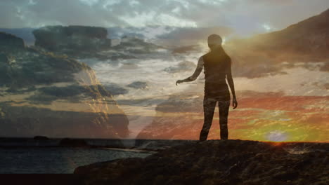 woman climbing rocks beside ocean