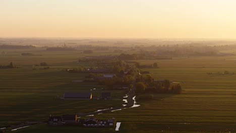 early misty morning in small rural town, majestic sunrise, aerial drone view