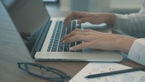 female hands typing on laptop telecommuting