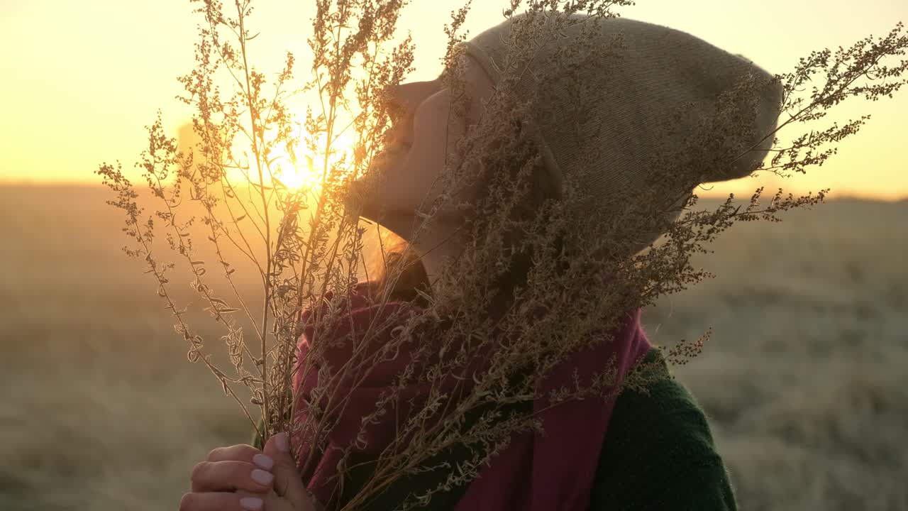 Woman enjoying sunrise in a field