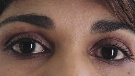 close up hispanic woman eyes opening wearing makeup looking at camera beauty cosmetics macro