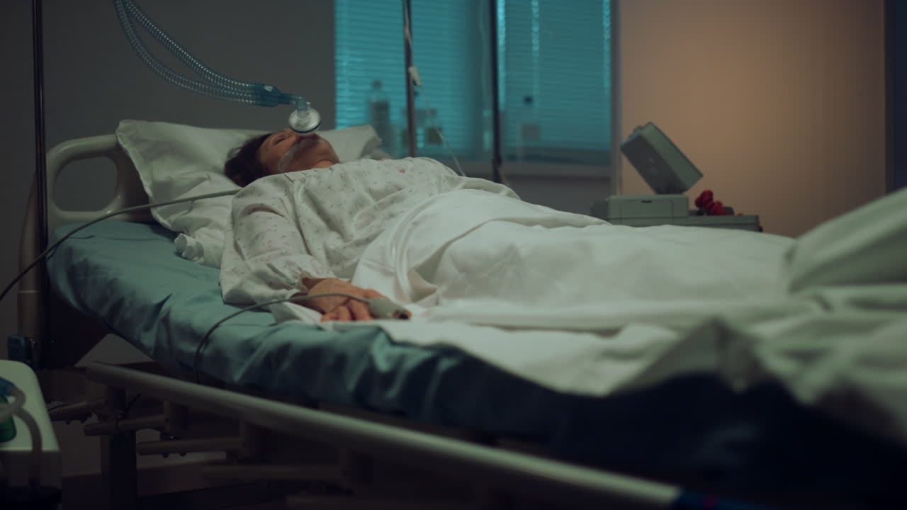 Patient connected artificial breathing tubes in hospital intensive care unit.
