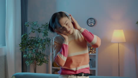 Woman Relaxing and Enjoying Music at Home