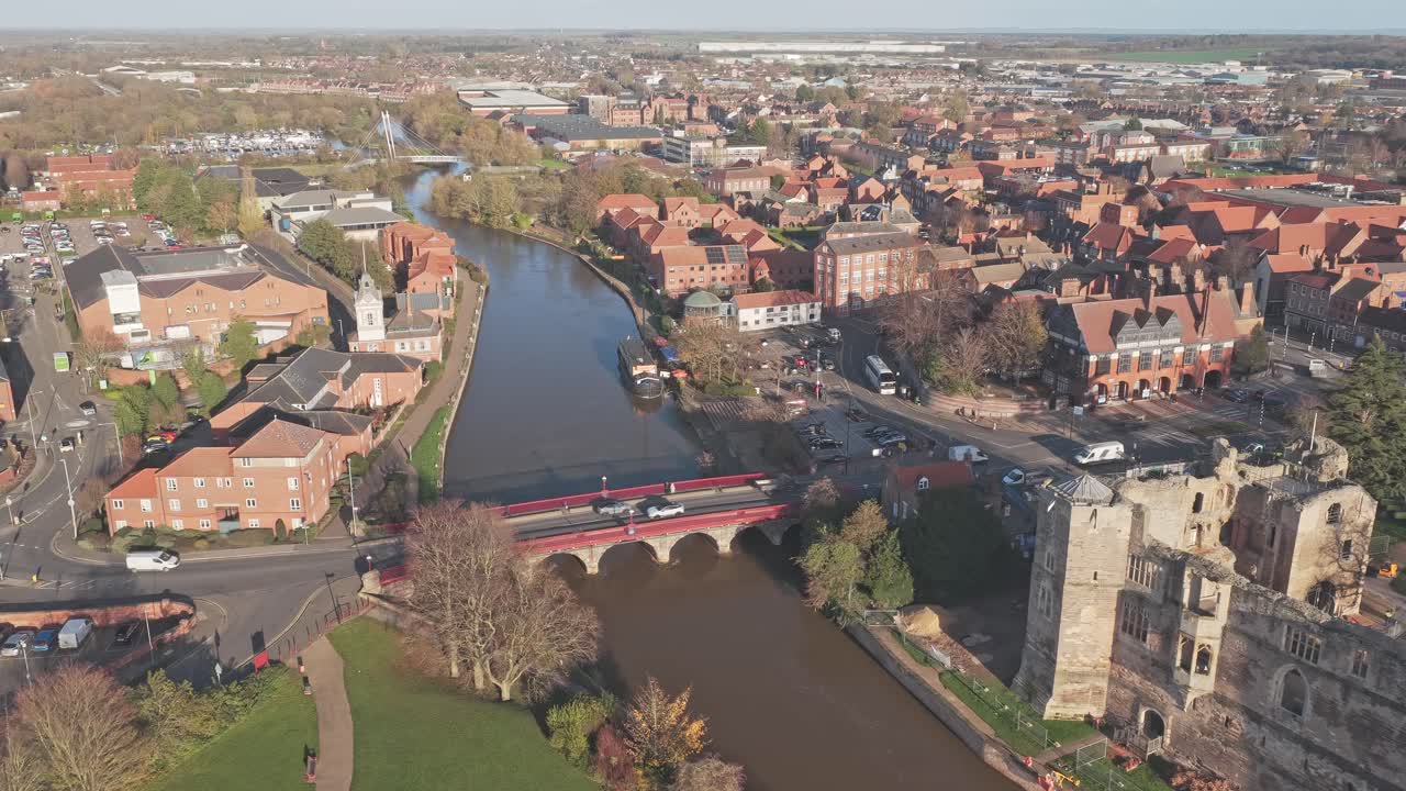 Newark Castle ruins and historic Trent Bridge spanning the River Trent, Newark-on-Trent, Nottinghamshire, UK, drone pulls away
