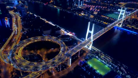 aerial view of roundabout of nanpu bridge, shanghai downtown, china. financial district and business centers in smart city in asia. top view of skyscraper and high-rise buildings at night.