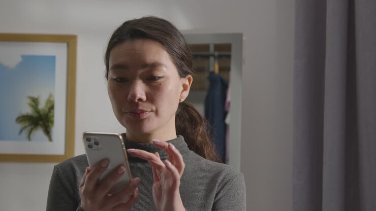 Disappointed Woman At Home Receiving Text Message Telling Her She Has Been Unsuccessful In Job Interview