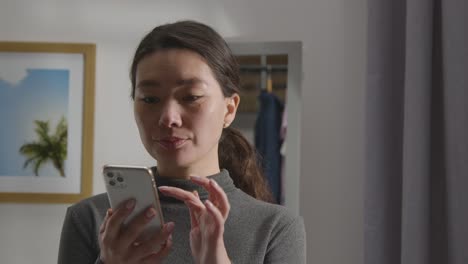 disappointed woman at home receiving text message telling her she has been unsuccessful in job interview